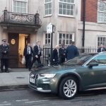 Queen Camilla smiles as she leaves hospital after visiting King Charles