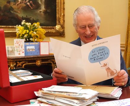 King amused by well-wisher’s card showing disgruntled cone-wearing dog