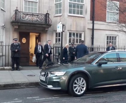 Queen Camilla smiles as she leaves hospital after visiting King Charles