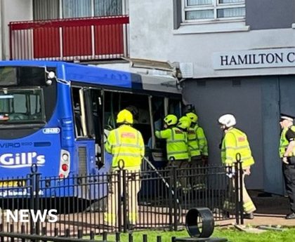 Five taken to hospital after bus crashes into flats